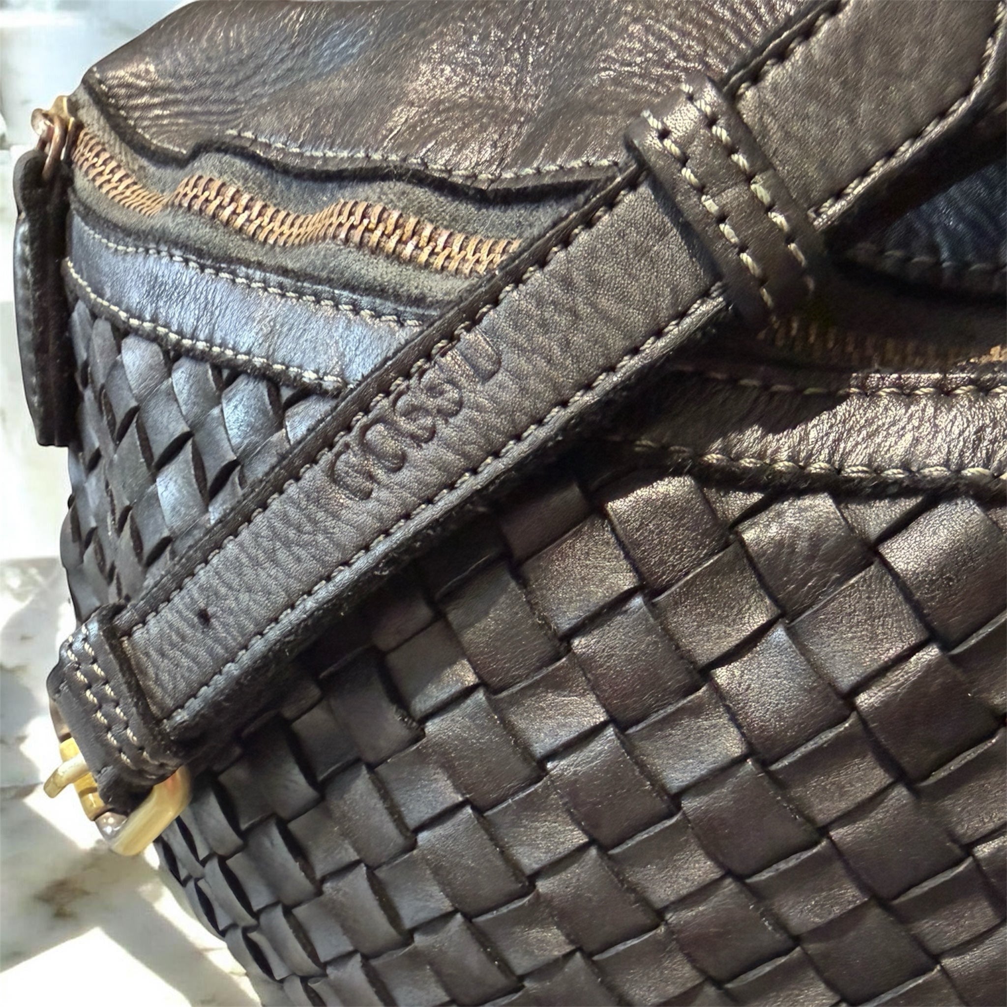 Woven Italian black leather handbag with strap showing logo Cossu 