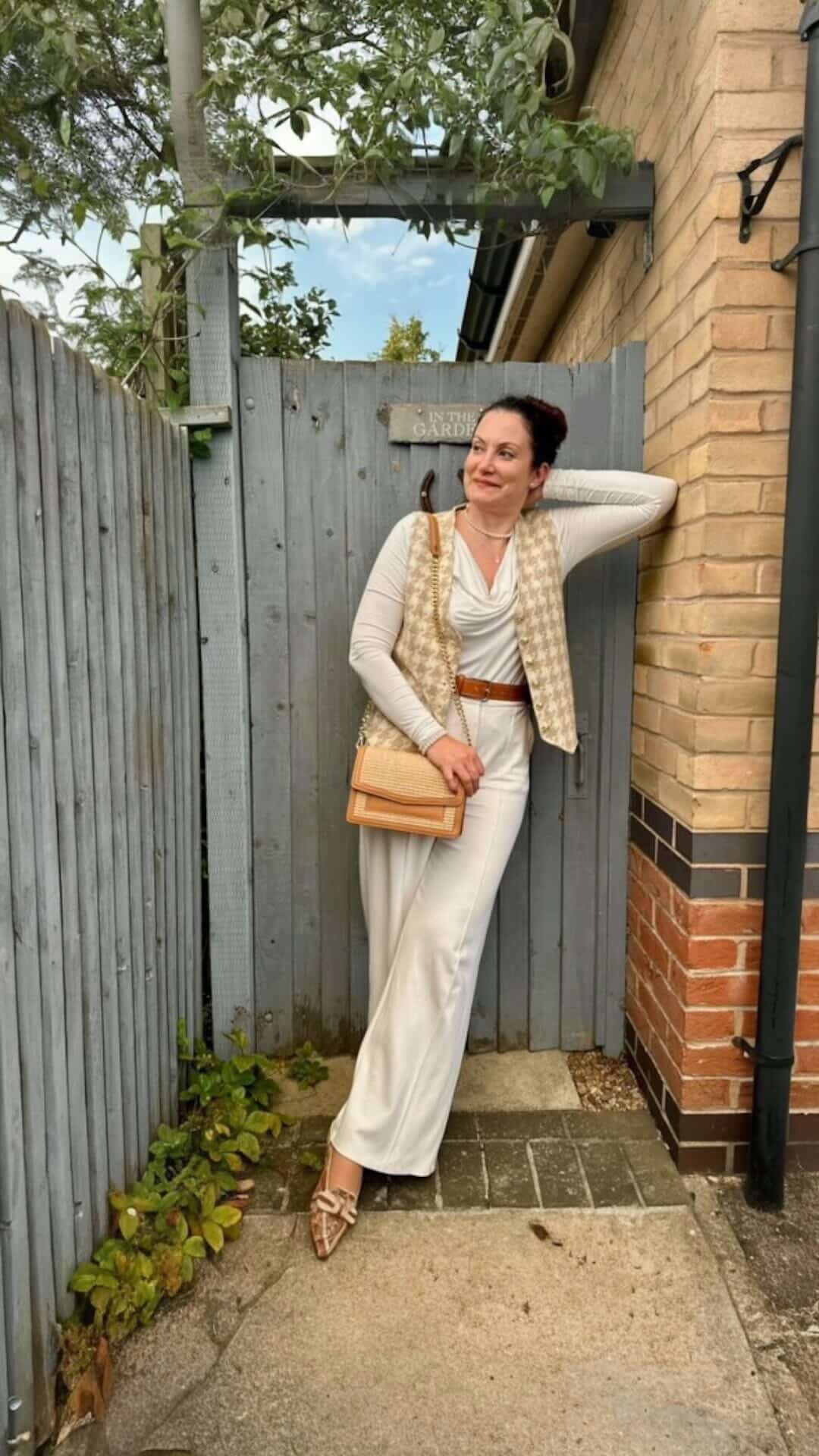 Lady with a tan colour raffia and leather handbag 