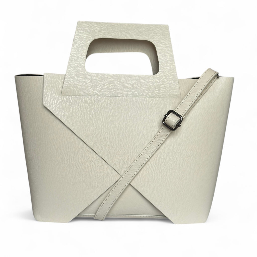 Cream colour Italian leather handbag with a unique handle and removable crossbody strap on a white background 
Removable zipped pouch inside the bag
Made in Italy 