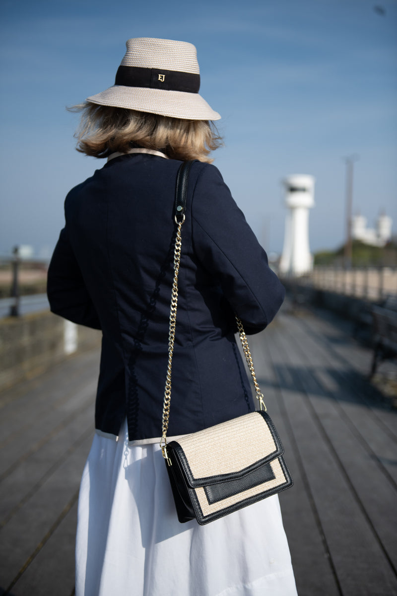 A lady wearing a raffia Italian leather handbag on her shoulder. Made In Italy Florence Sussex Kent Surrey Independent label 