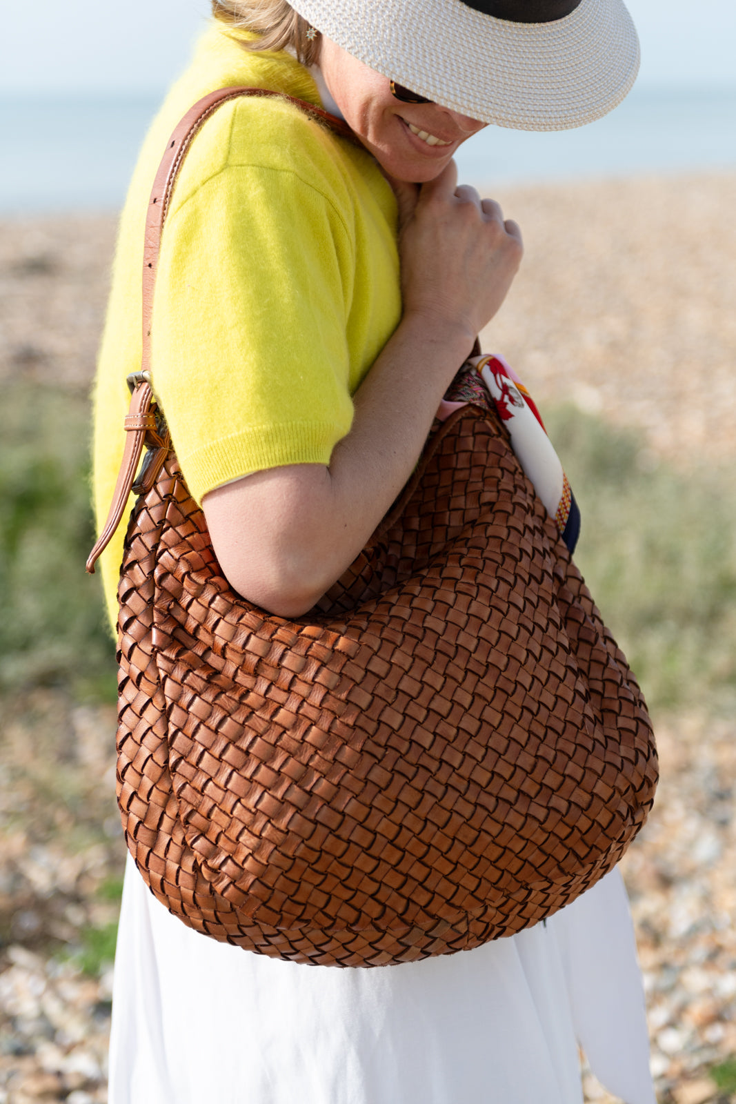 Lady with a tan hand woven Italian leather hobo bag on her shoulder made in Italy Florence Sussex independent retailer 