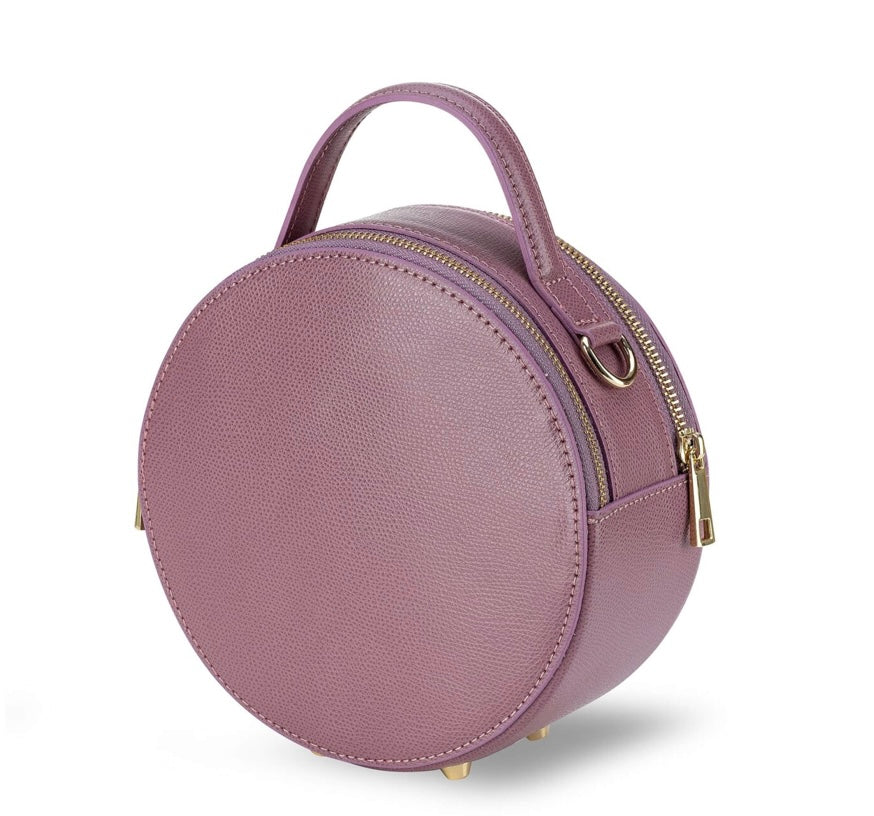 Round lilac handbag with a gold zipper on a white background