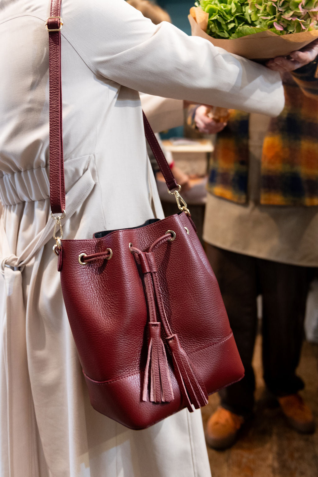Lady shopping with her wine coloured bucket bag Italian leather handbag