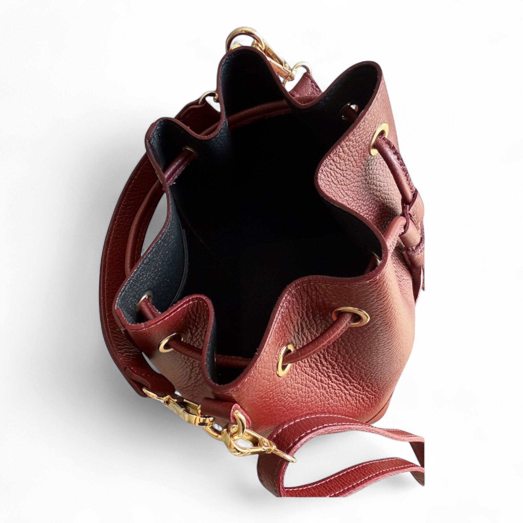 Showing inside of a wine coloured Italian leather bucket bag 