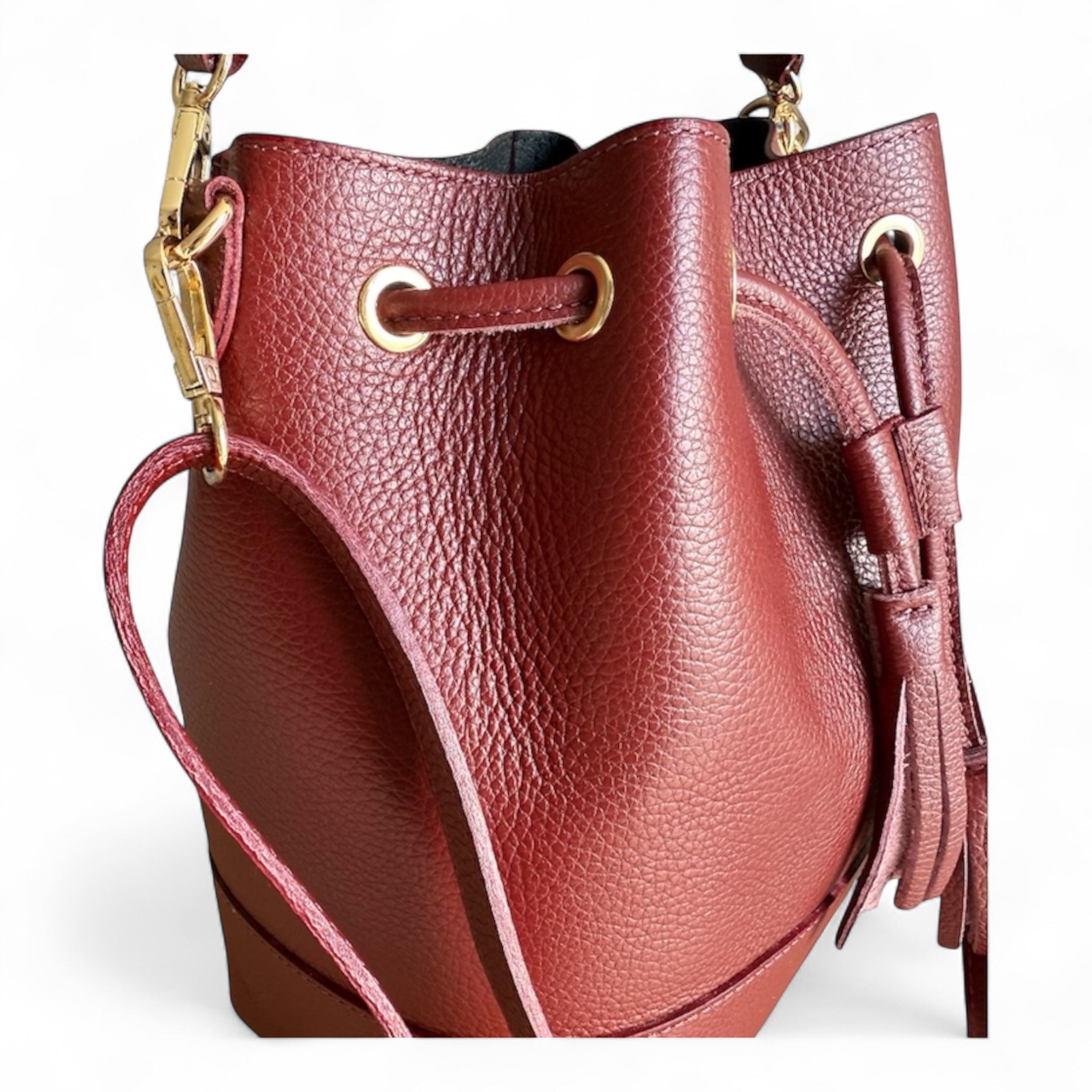 Wine Italian leather bucket handbag with gold accents on a white background removable shoulder and top handle straps made in Italy 