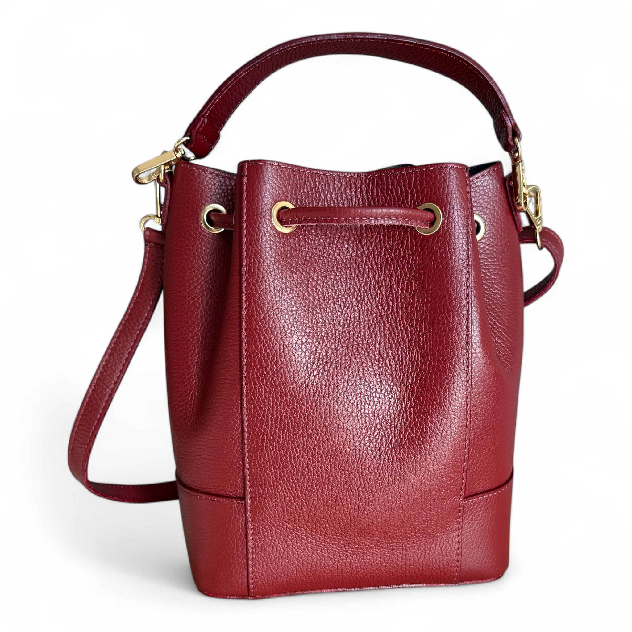 Showing the back of a wine Italian leather bucket handbag with a removable shoulder and top handle strap made in Italy 