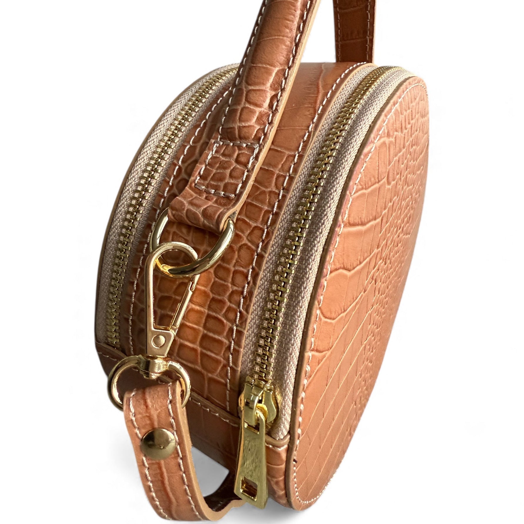 Brown tan textured Italian leather handbag with gold zipper on a white background round shape removable shoulder strap 