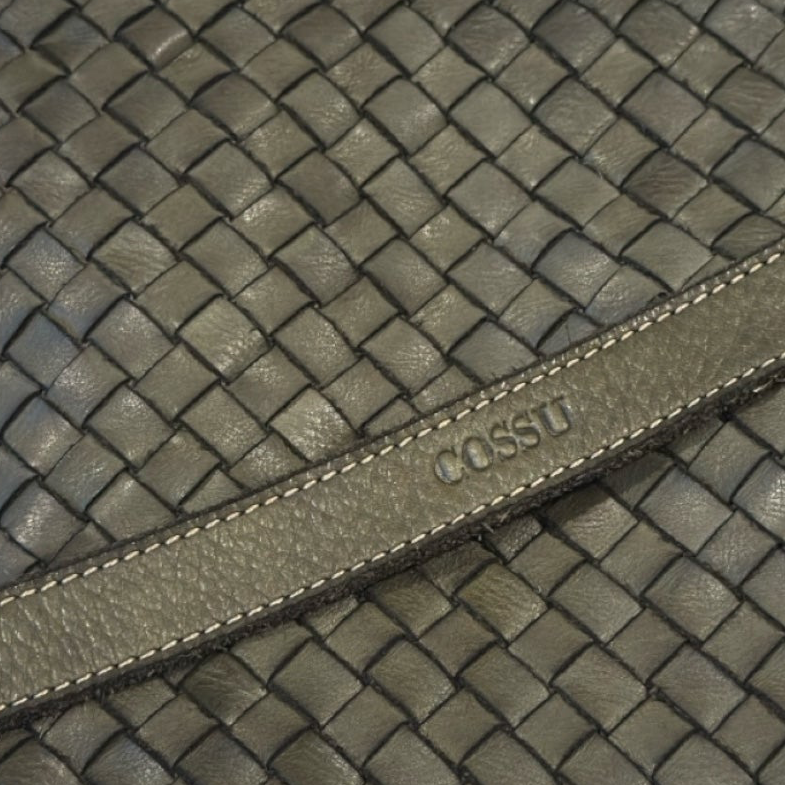 Close up of an Olive green Italian leather bag woven with logo Cossu made in Italy UK business 