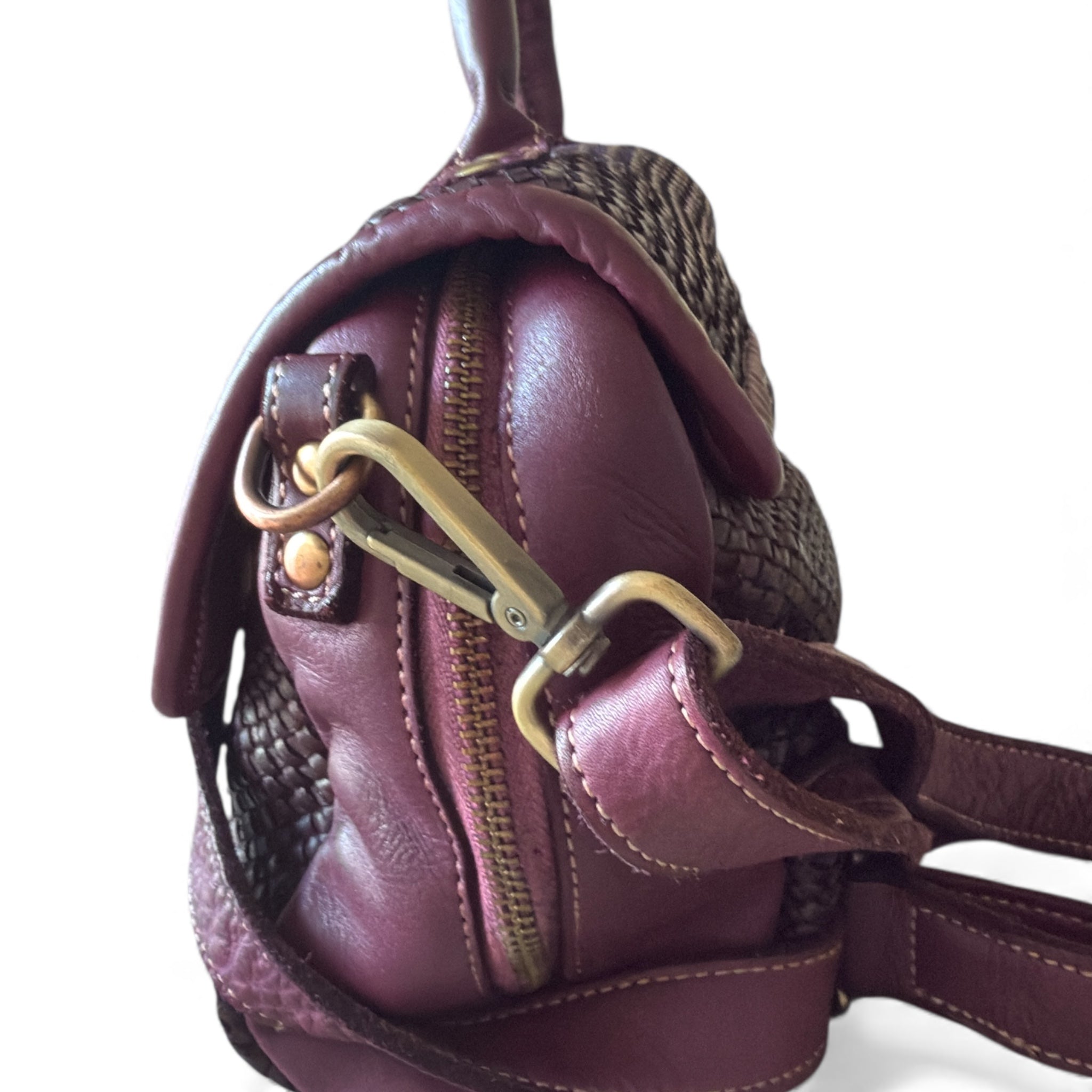 Close up of a handwoven Italian leather bag the colour is burgundy made in Italy Sussex Kent Surrey Independent handbag retailer 