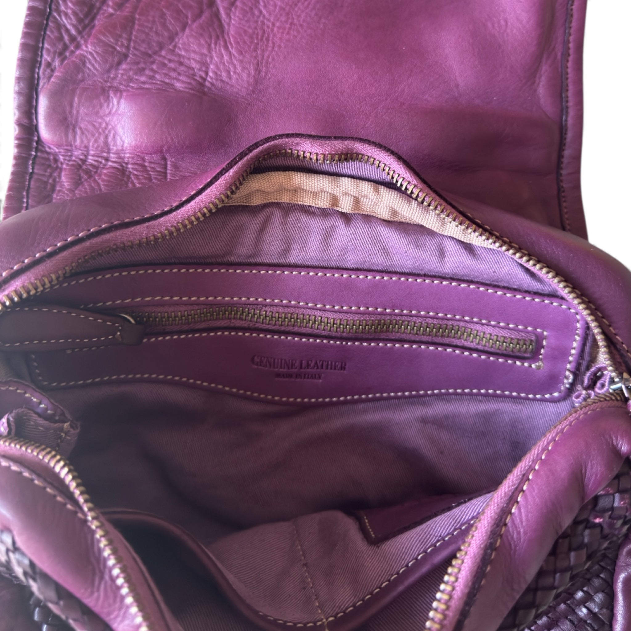 Close up inside of a hand woven bag inside zipped pocket burgundy Sussex Horsham handbags 