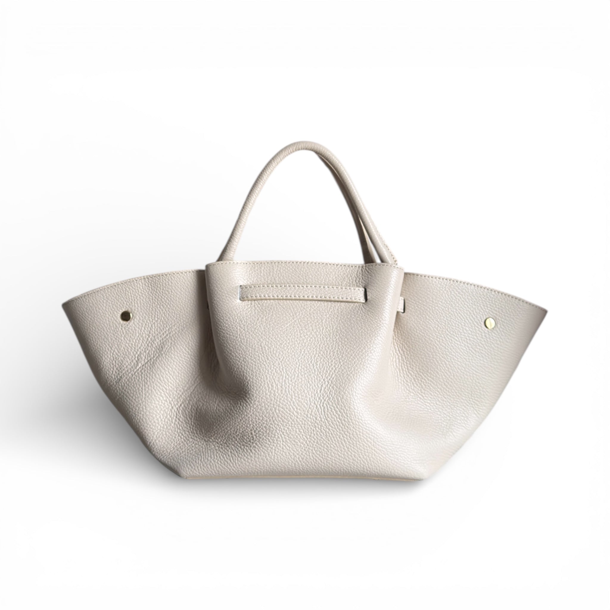 Showing the back of a cream leather handbag 