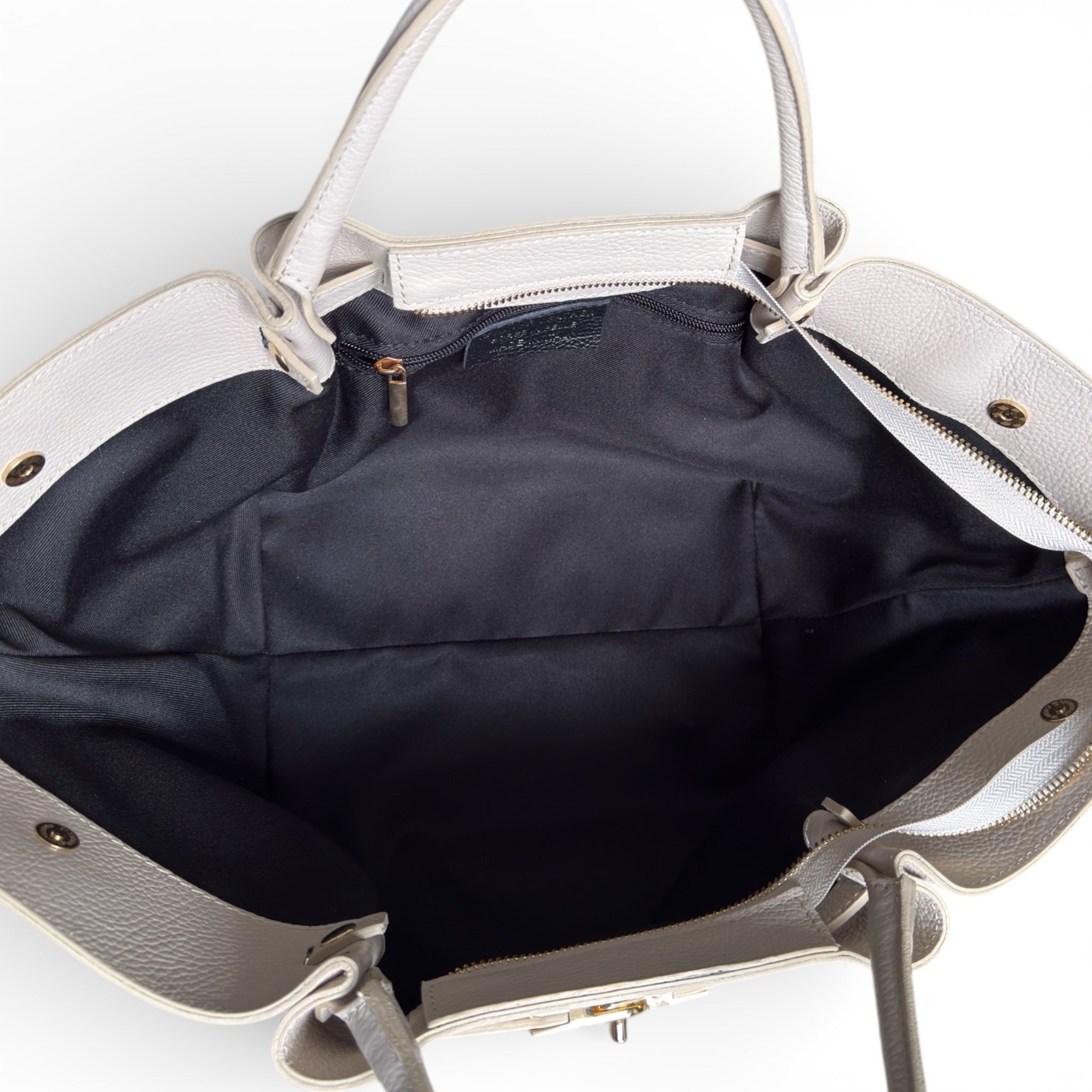 Showing inside of a cream leather handbag 