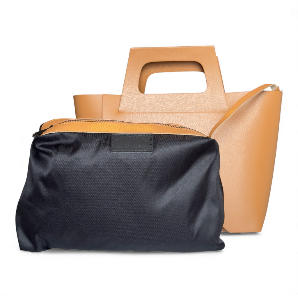 Italian leather Handbag showing detachable inside pouch on a white back ground