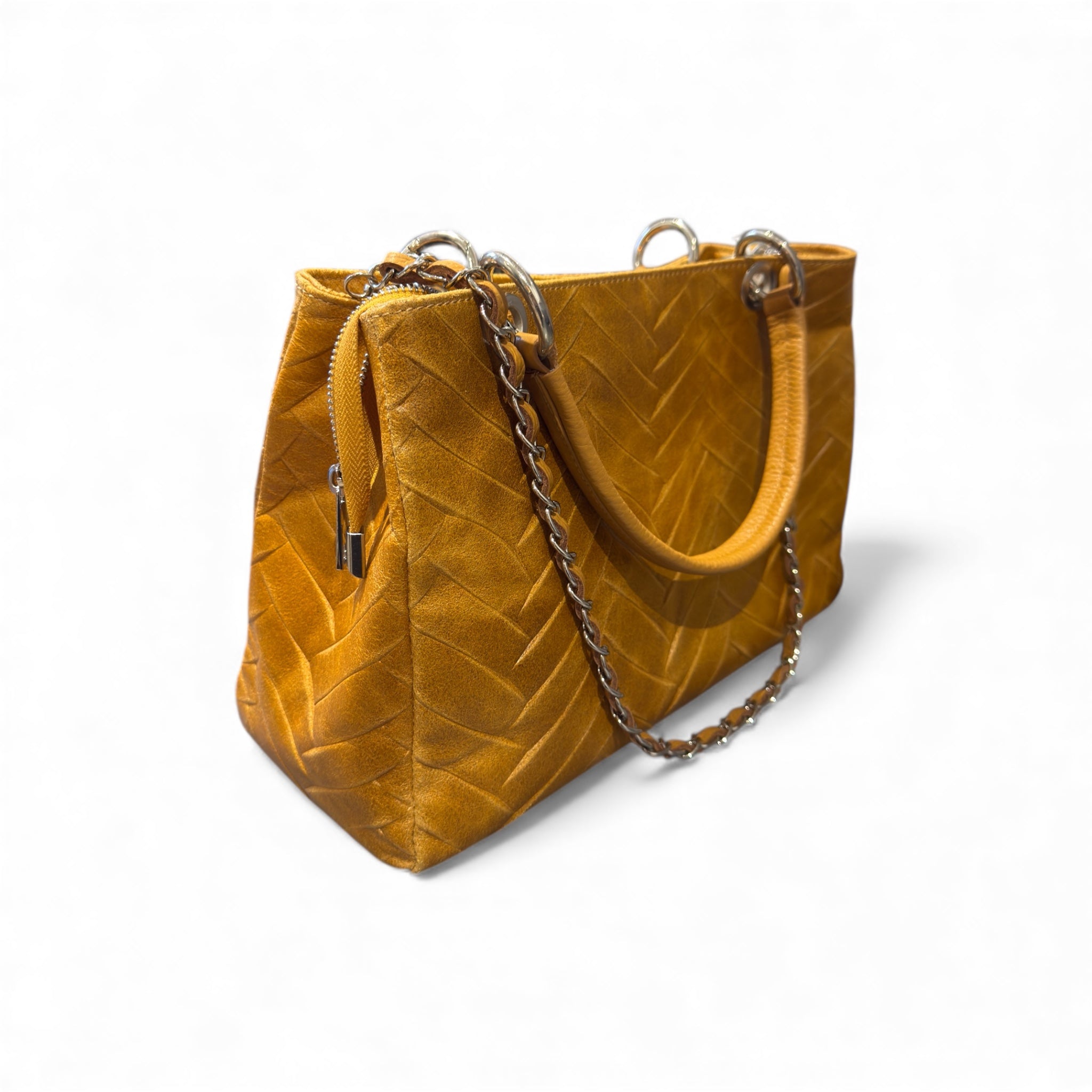 Mustard tan Italian leather handbag with a chain detail on a white background