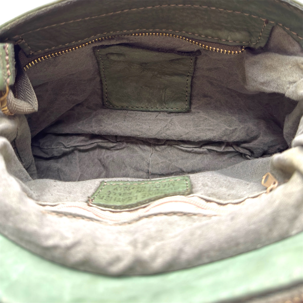 Showing the inside of a leather Italian handbag olive green zip pocket 