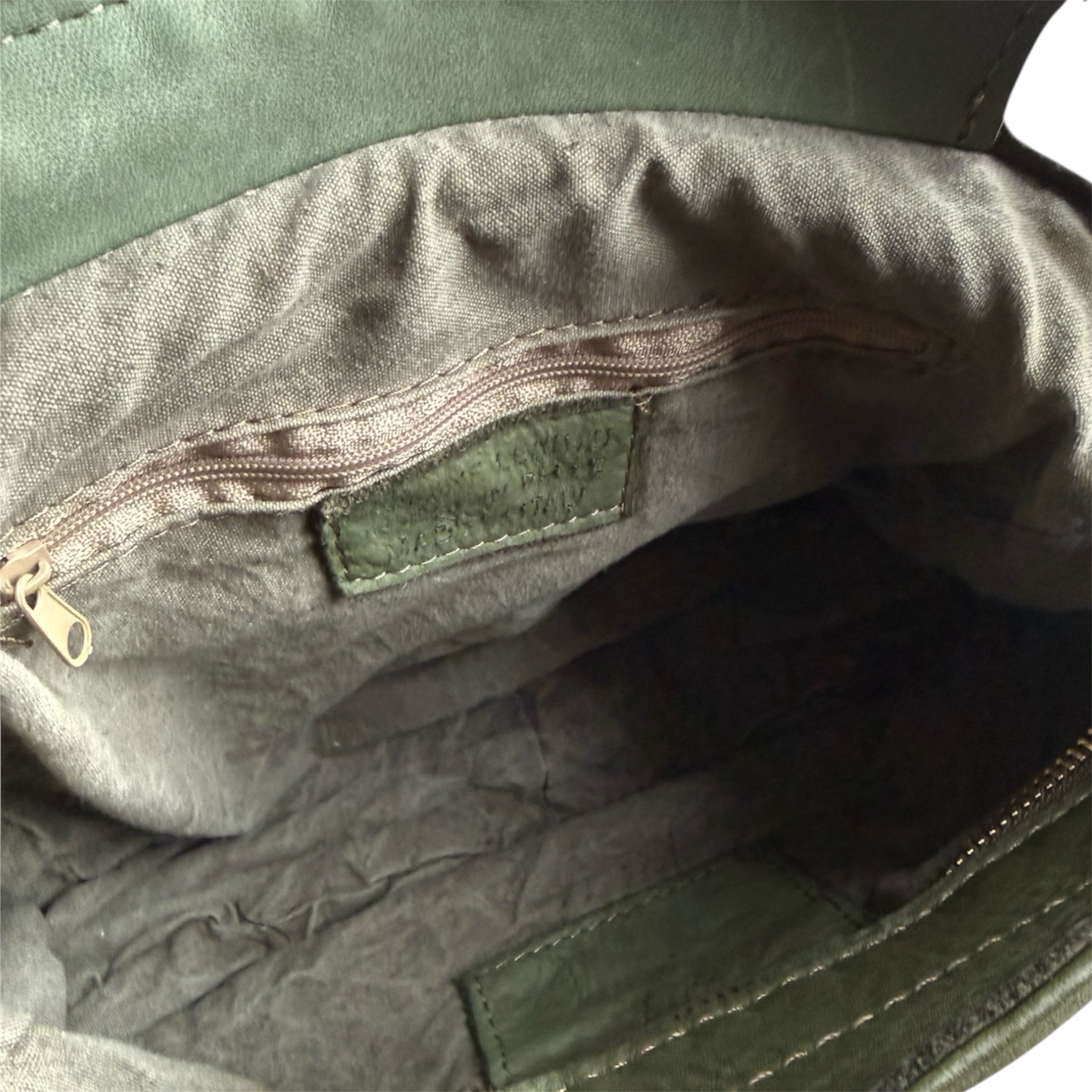 Showing the inside of an Olive green woven leather handbag 