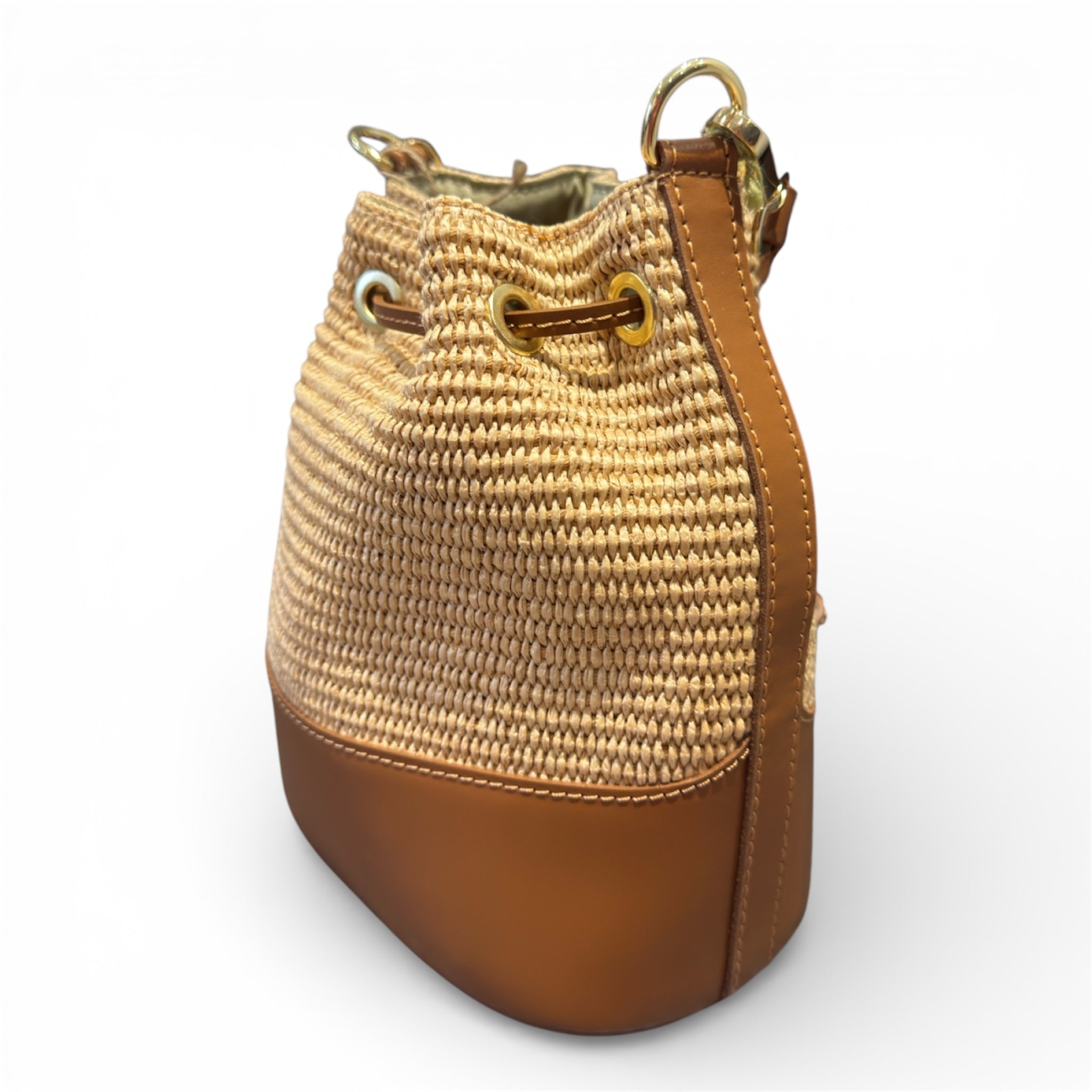 Woven bucket leather bag with brown leather accents on a white background