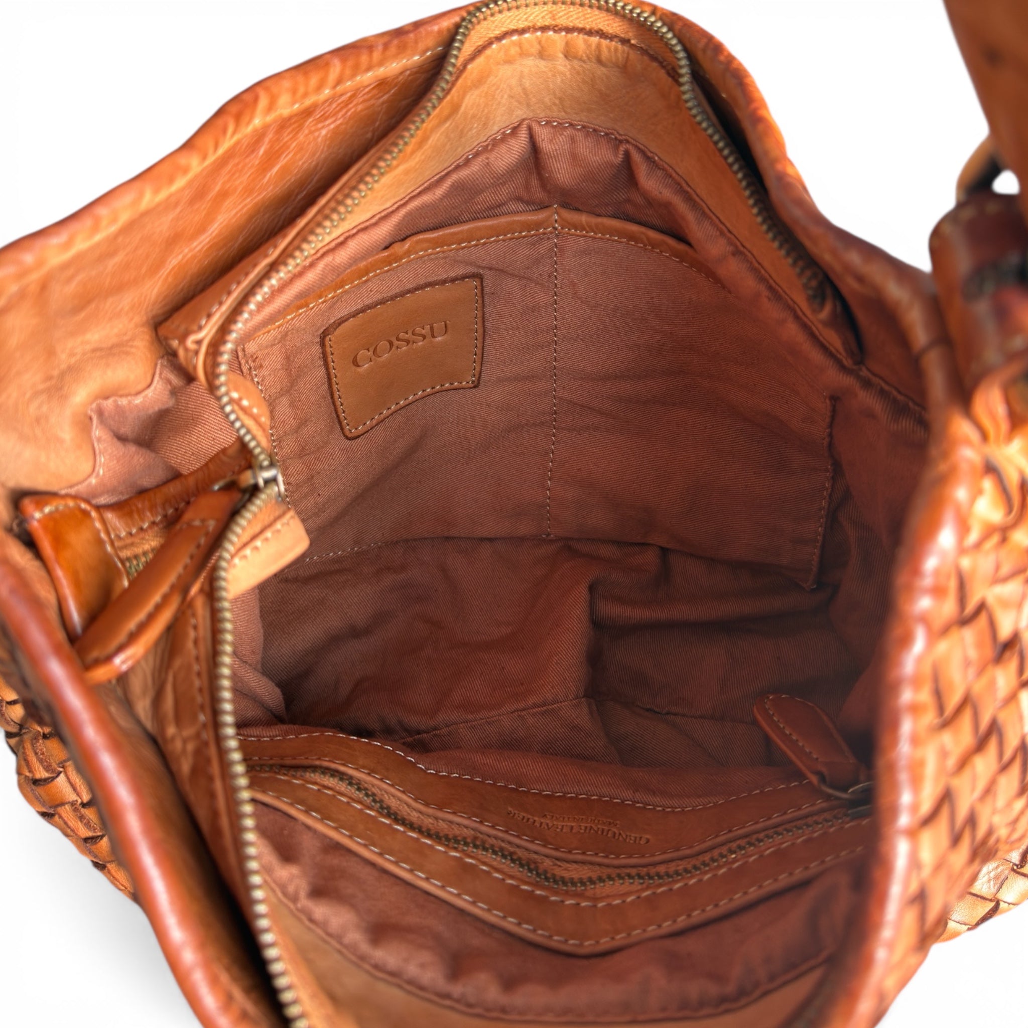 Showing inside a tan leather handbag with Cossu logo showing U.K. independent handbag retailer 