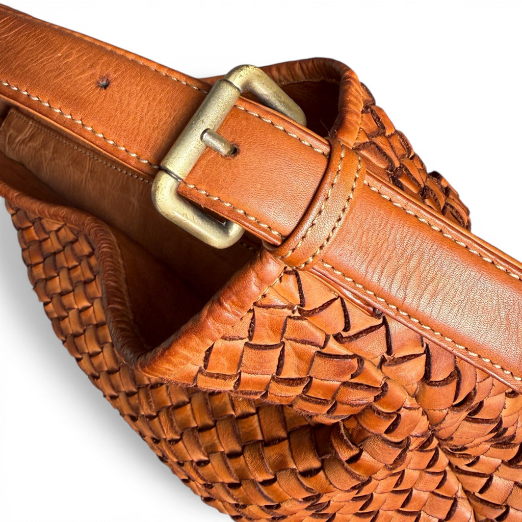 Close up of buckle on tan leather handbag 