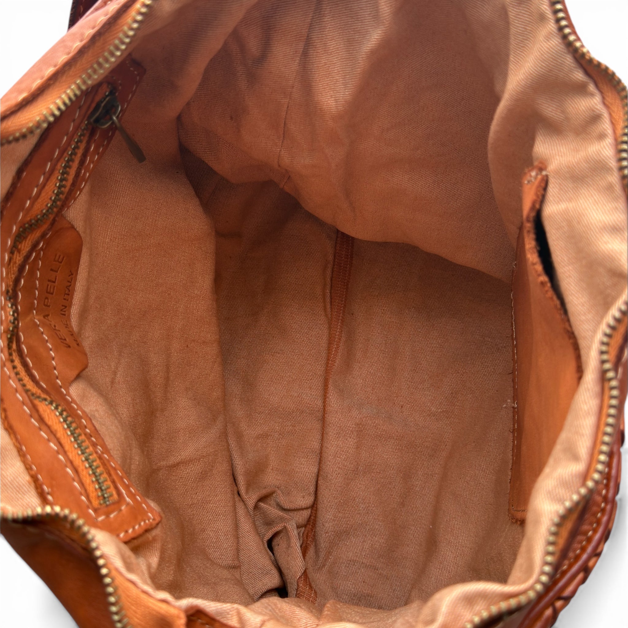 Close-up of a tan Italian leather bag with visible stitching made in Italy calf leather woven 