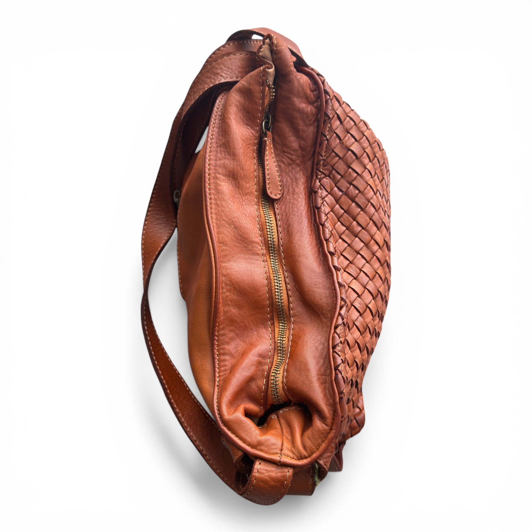 Tan woven Italian leather hobo bag with woven pattern on a white background, showing the main zip closure 