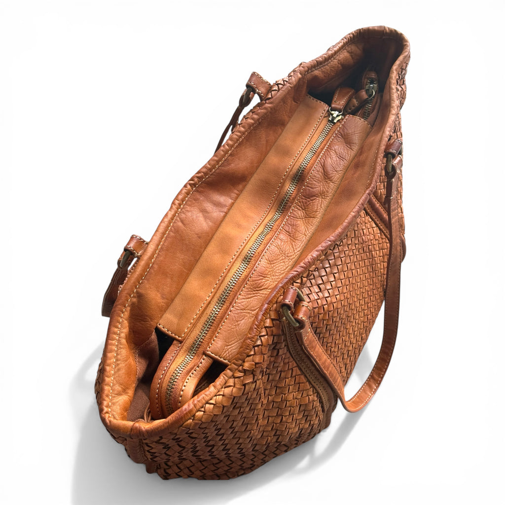 Close up showing main zip closure of a tan colour hand woven Italian leather tote bag on a white background made in Italy Florence