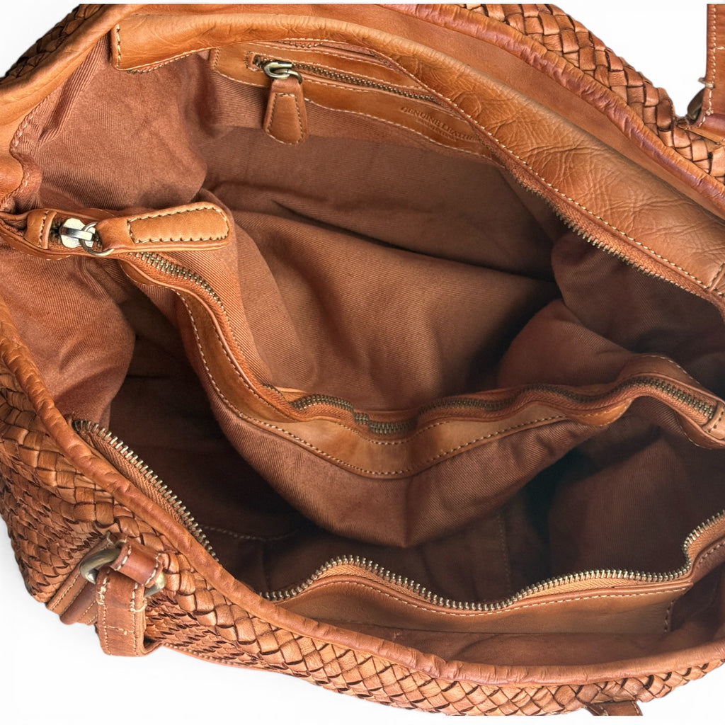 Close-up of a tan hand woven Italian leather handbag tote with handle and interior. U.K. independent label made in Florence Italy 