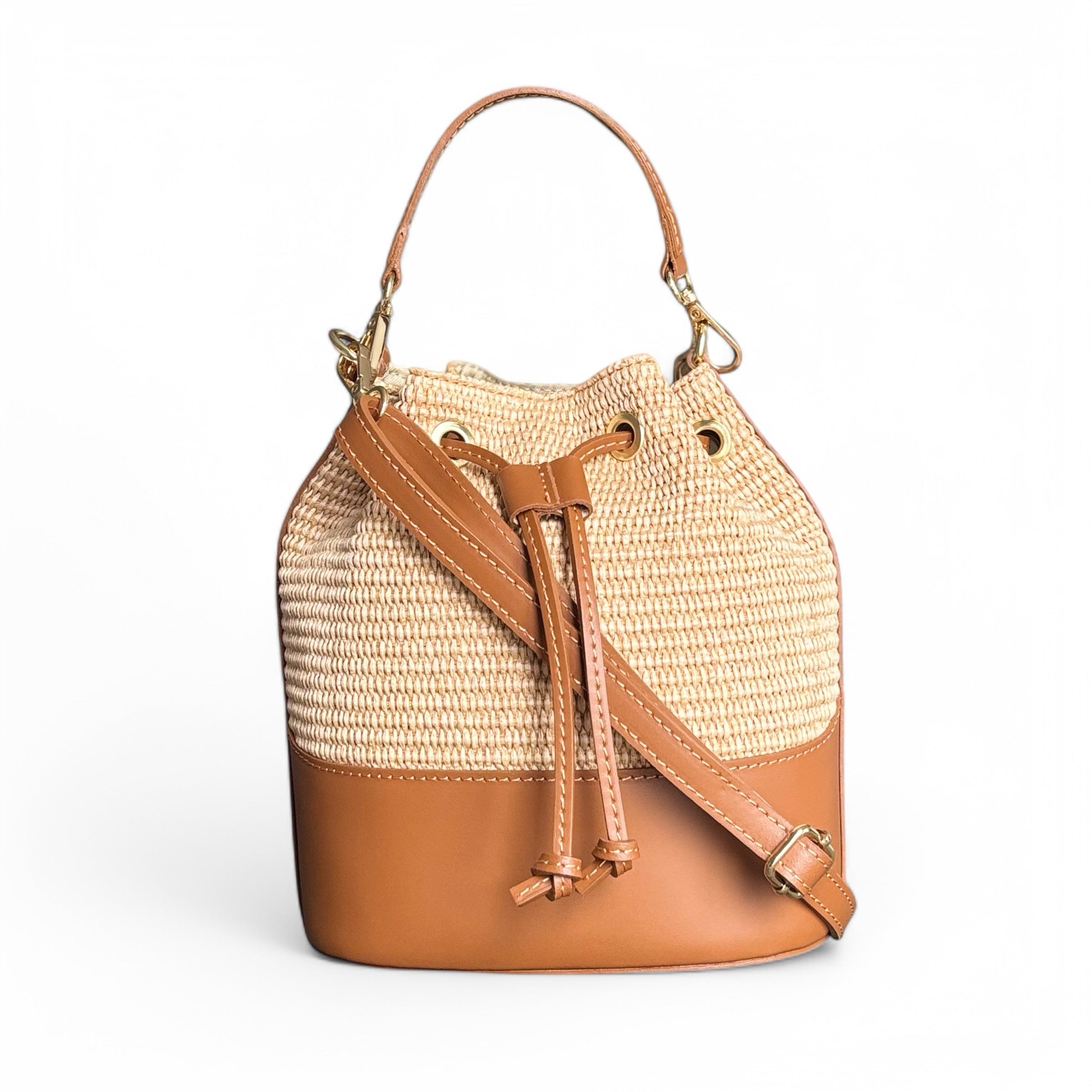 Italian raffia and leather bucket bag 
Colour Tan and natural raffia 
Imported from Italy 
Removable shoulder strap 
Sussex Kent Surrey Independent handbag retailer 